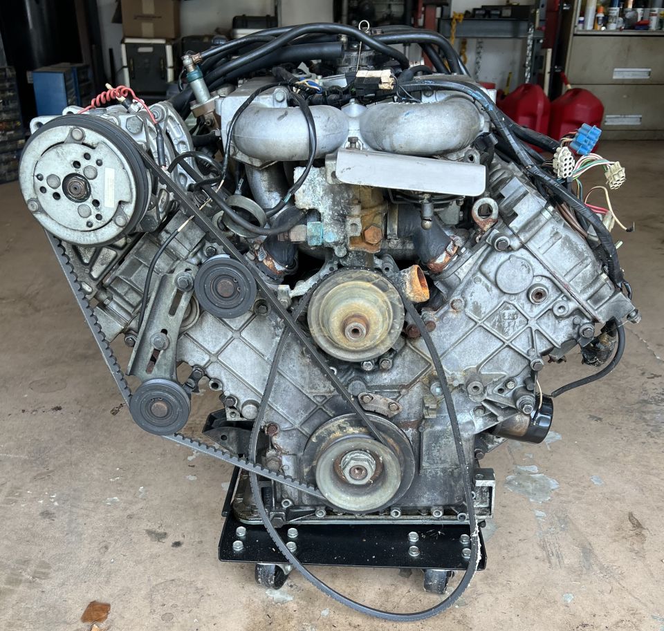 Used Ford V8 engine on a shop dolly with intake and timing cover