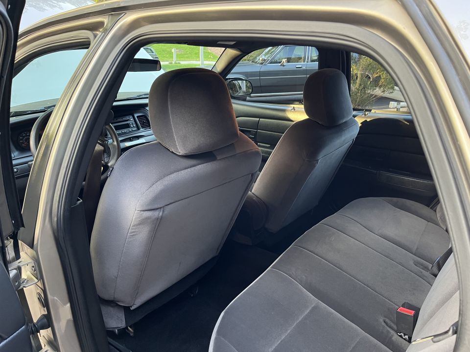 Rear seat area of a Ford sedan with front seat headrests in view