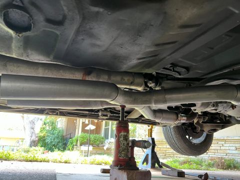1981 Ford LTD - Using a bottle jack to tuck the X up into the body better. Just cut a couple tacks on top to let it flex. Easy.