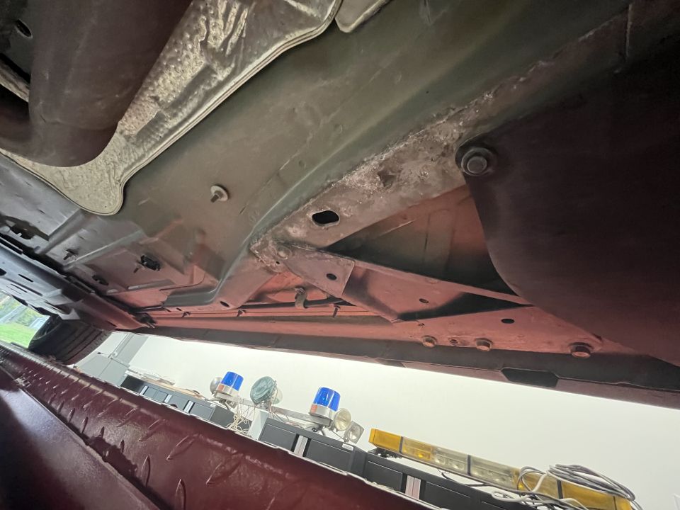 Undercarriage photo showing painted floor pan and frame seam