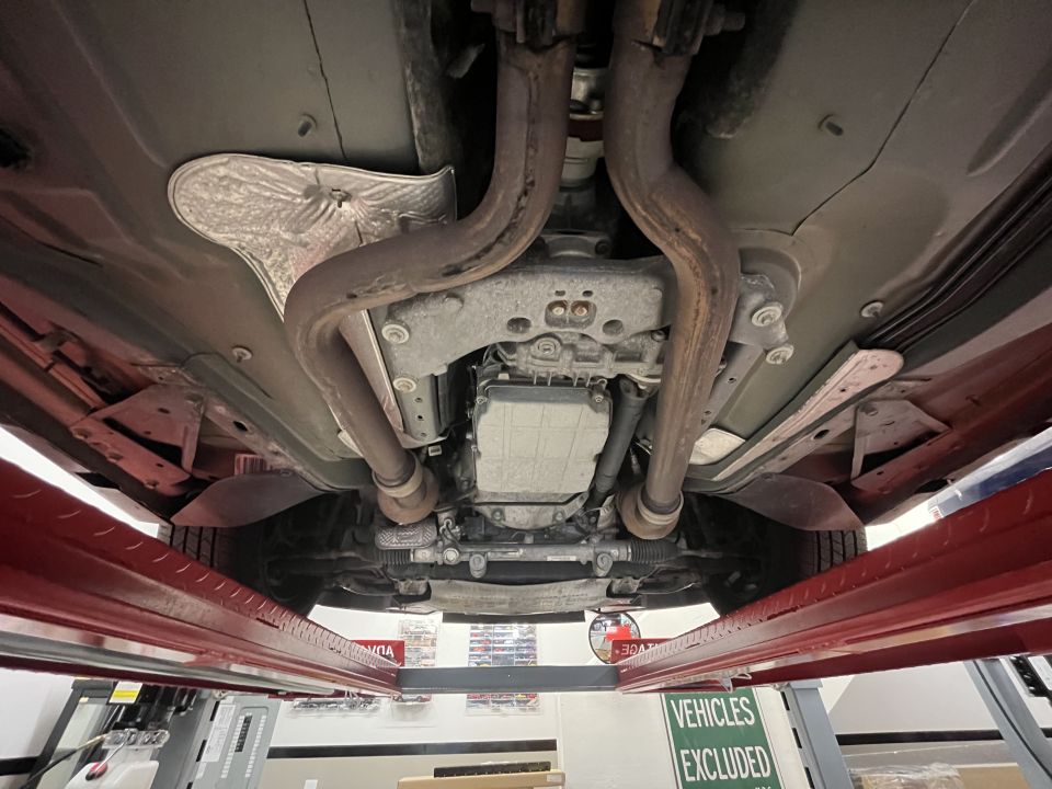 Undercarriage photo of driveshaft, transmission and exhaust pipes