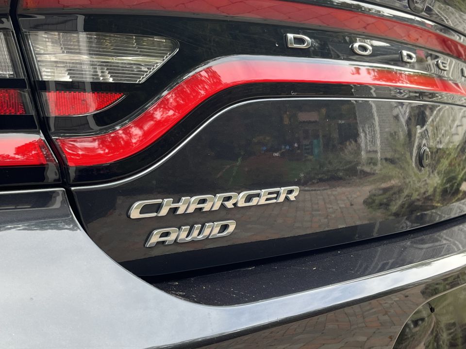Close-up photo of Dodge Charger AWD trunk badge and taillight
