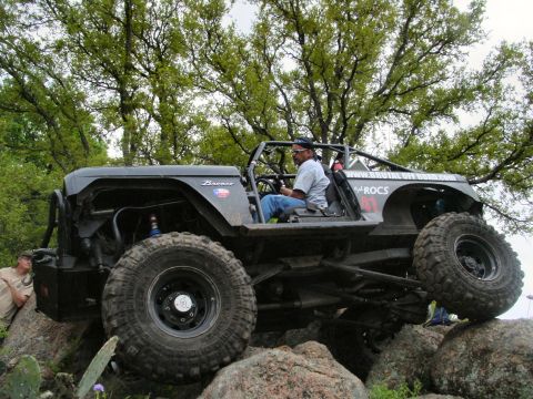 1973 Ford Bronco - A modified 1973 Ford Bronco navigates a rocky terrain during an off-road event.