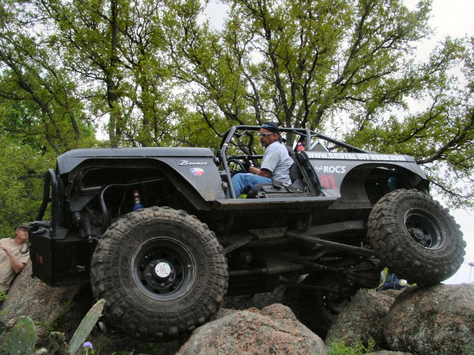 1973 Ford Bronco on rocks, side view, black