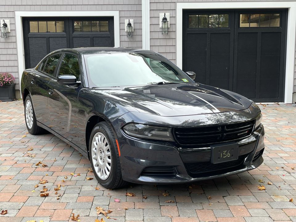 Front passenger-side view of a dark Dodge Charger