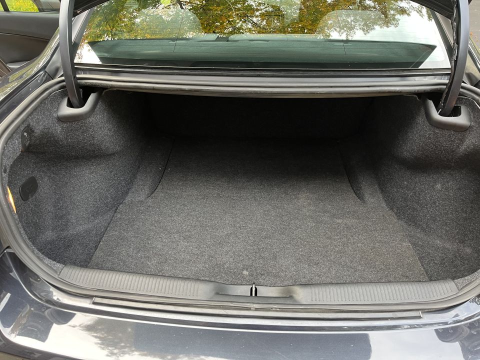 Open carpeted trunk of a Dodge Charger