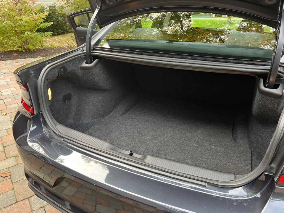 Open trunk of a Dodge Charger viewed from the rear