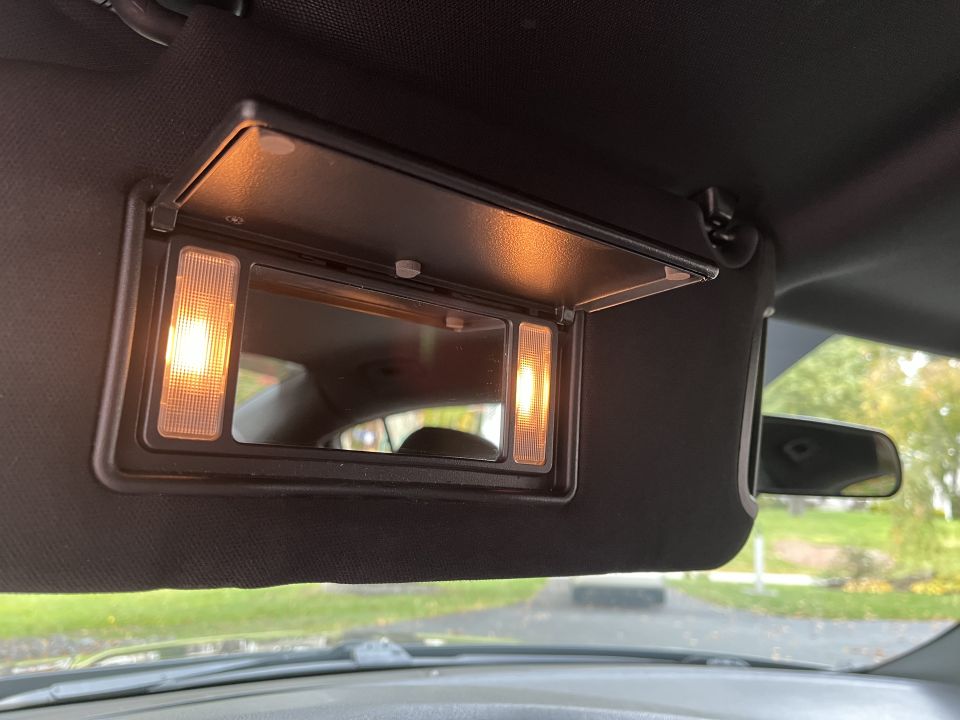 Lit vanity mirror in the sun visor of a Dodge Charger