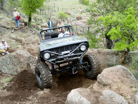 1973 Ford Bronco - A modified 1973 Ford Bronco navigates a challenging rocky terrain during an off-road event.
