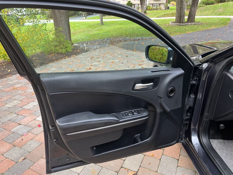 Open front door and interior door panel of a Dodge Charger