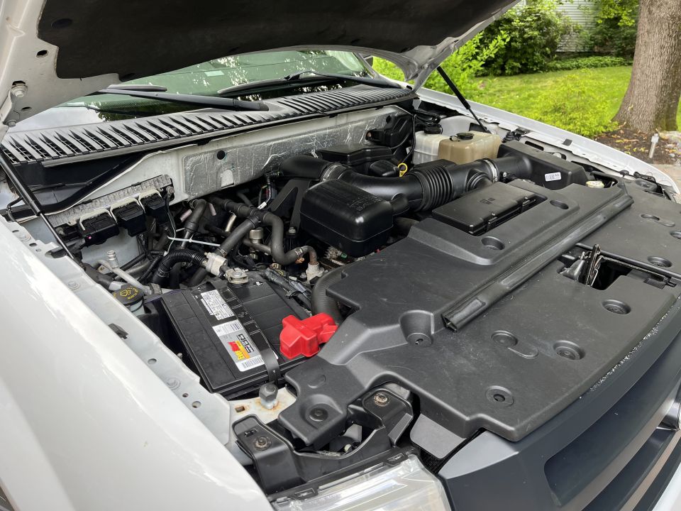 Engine bay showing battery, intake and engine cover