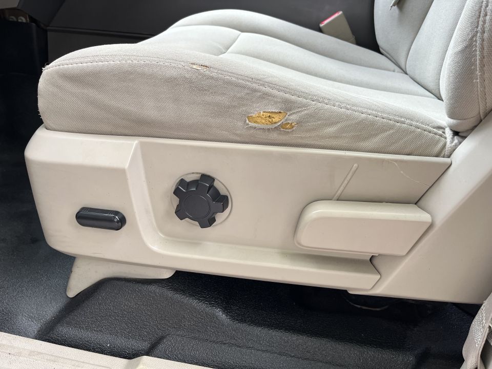 Power seat base with adjustment controls and worn cloth cushion