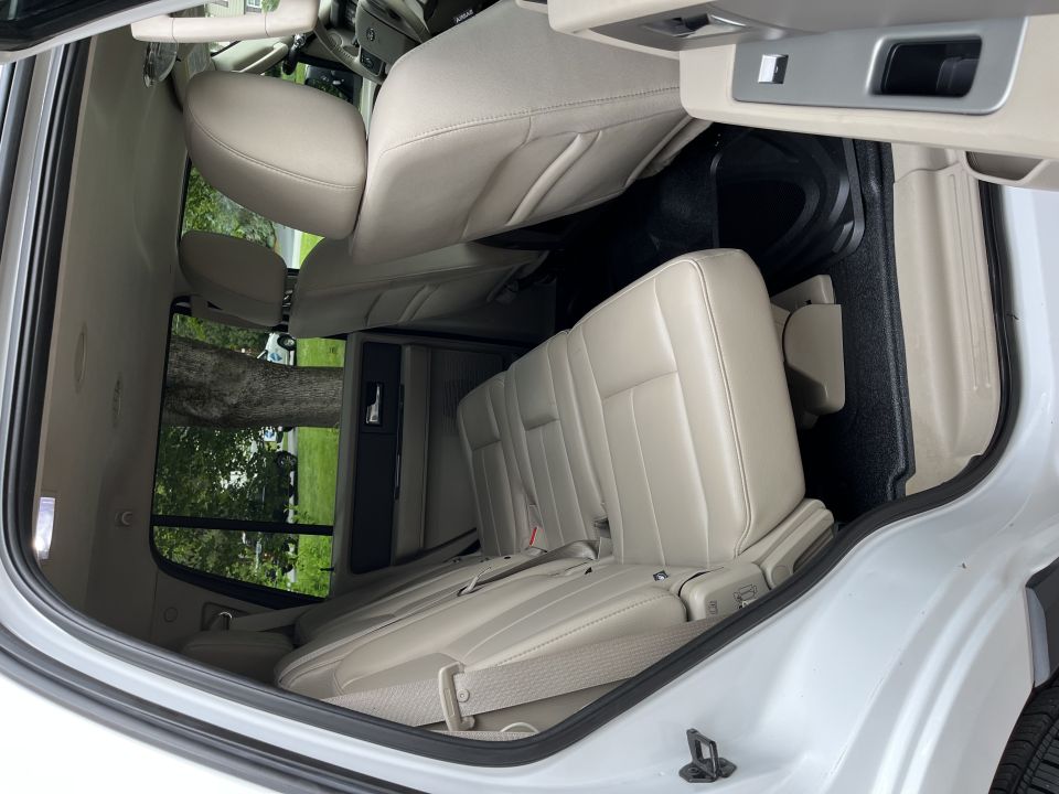 Second-row leather seats viewed through open rear door
