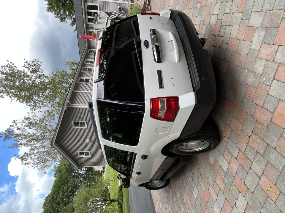 Rear three-quarter view of white Ford Expedition