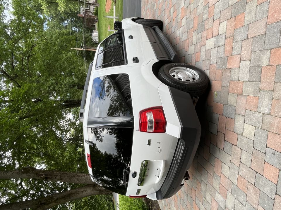 Rear three-quarter passenger side of white Ford Expedition