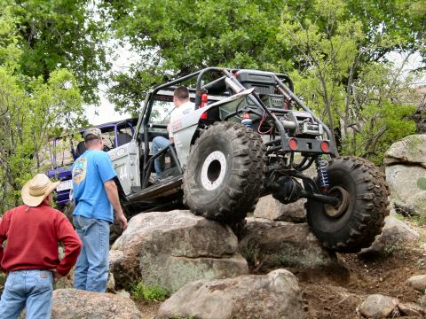 1973 Ford Bronco - This heavily modified off-road buggy navigates a rocky trail with another vehicle visible behind it.