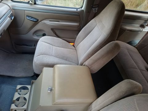 1994 Ford Bronco - Interior view of a vehicle's front seats and dashboard area.