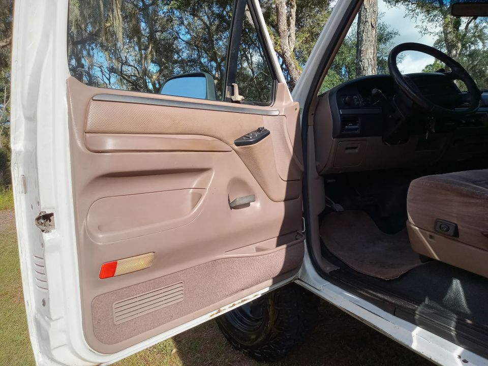 Interior door panel and dashboard of a 1994 Ford Bronco