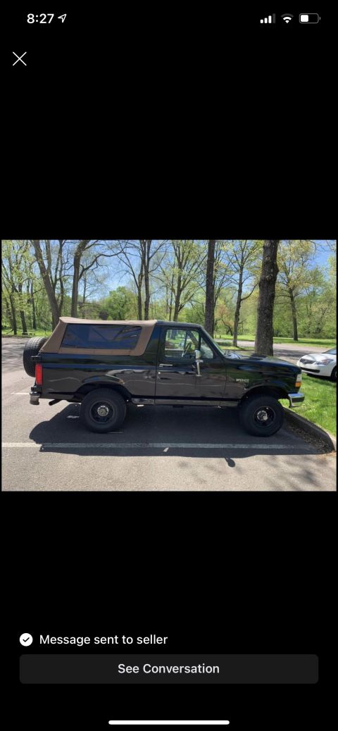 1994 Ford Bronco - Side view of a 1994 Ford Bronco with a spare tire on the rear.