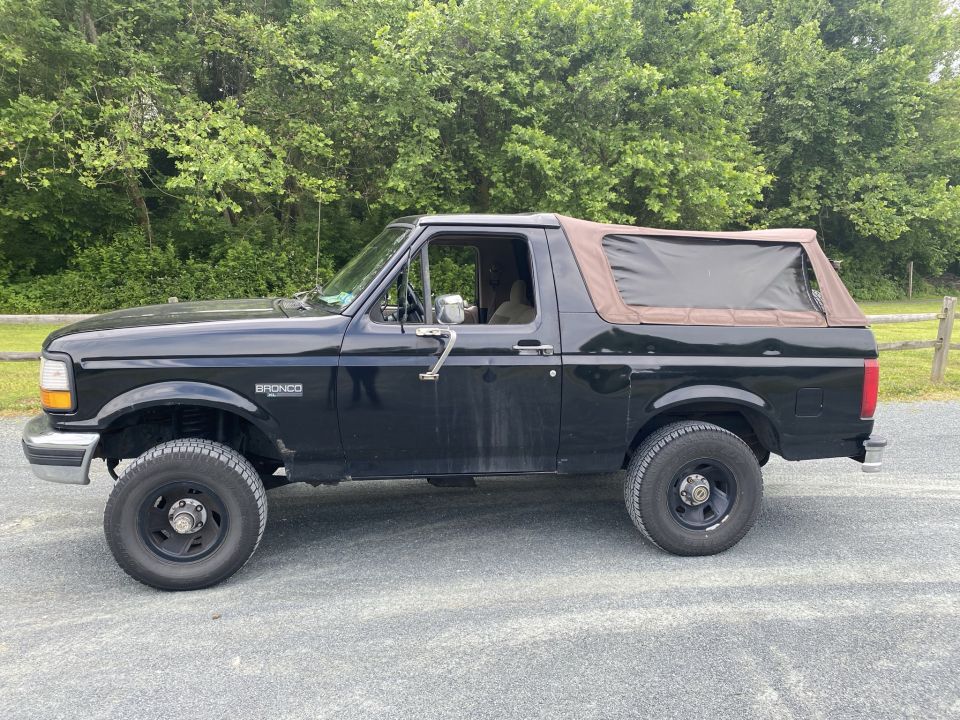 1994 Ford Bronco side profile with brown soft top