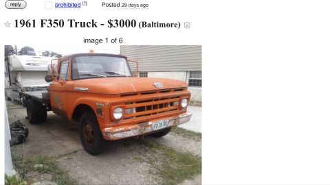 1961 Ford F-350 - This orange flatbed truck, possibly a 1961 Ford F-350, is shown with a camper loaded onto its bed.