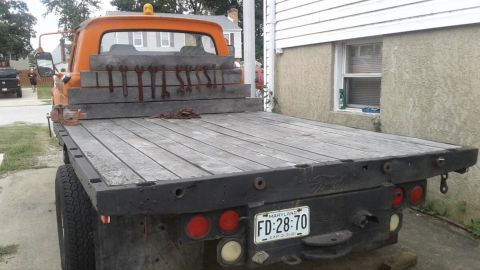 1961 Ford F-350 - This flatbed truck has a wooden cargo bed and a Maryland license plate.