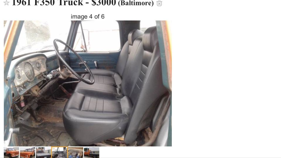 1961 Ford F-350 interior with black vinyl bench seat, blue dashboard, and steering wheel