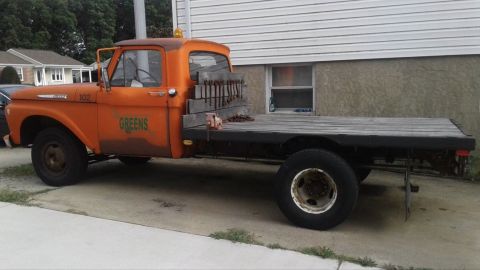 1961 Ford F-350 - Side view of an orange 1961 Ford F-350 flatbed truck parked outside.