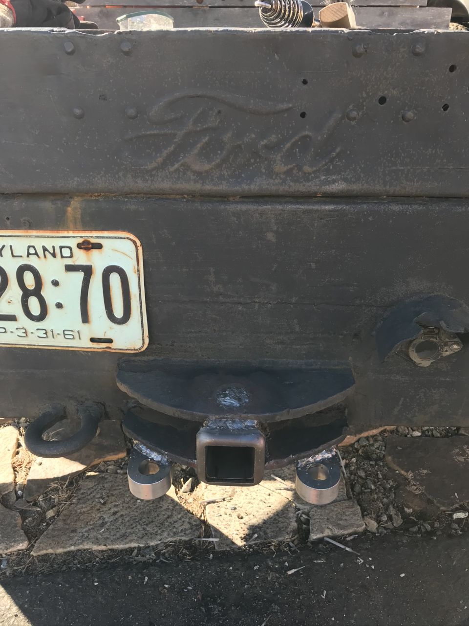 Rear of a Ford truck showing a hitch receiver and a Maryland license plate dated 3-31-61