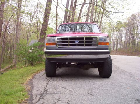 1995 Ford Bronco - Front view of a red 1995 Ford Bronco parked on a paved road.