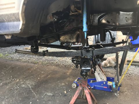 1985 Ford F-350 - The front axle and leaf springs of a 1985 Ford F-350 are shown during a rebuild and paint process.
