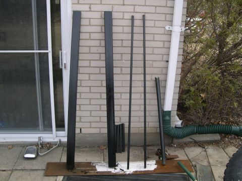 1986 Ford Bronco - Assorted black trim pieces are displayed on a patio, possibly for a vehicle.