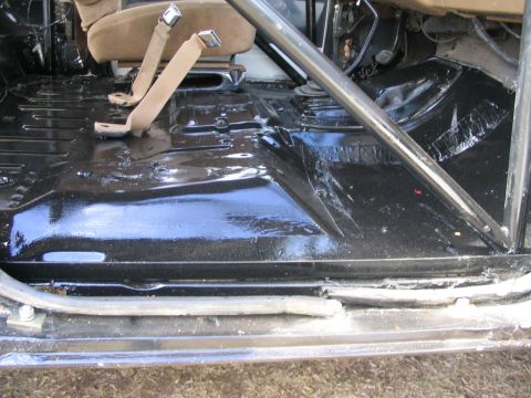 1986 Ford Bronco - The interior floor and seat belts are visible in this image.