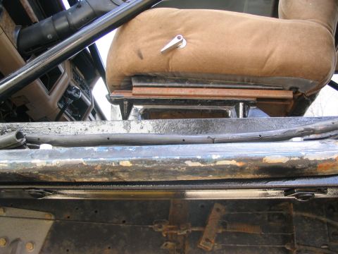 1986 Ford Bronco - Interior view of a 1986 Ford Bronco, focusing on the seat and roll cage structure.