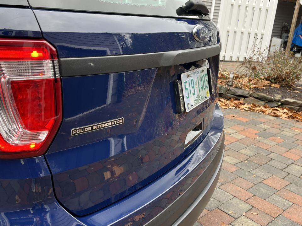 Photo of a blue Ford Police Interceptor SUV tailgate with badge