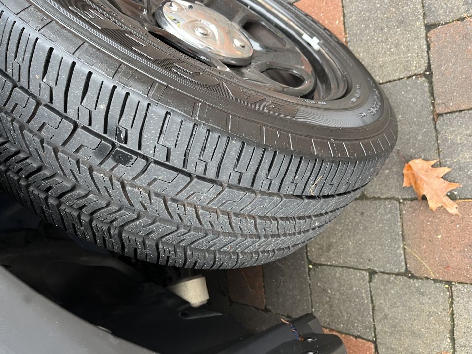 Close-up photo of a tire tread and wheel on a vehicle