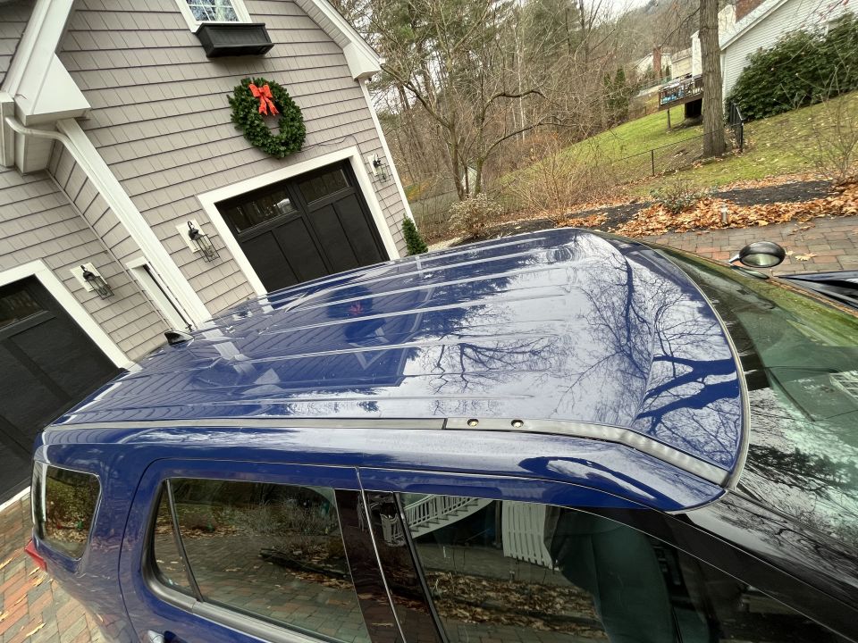 Overhead photo of the roof and windshield of a blue SUV