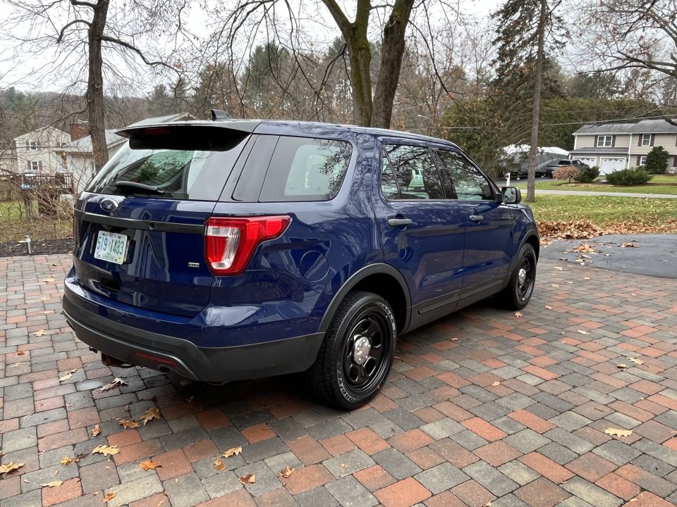 Rear three-quarter photo of a blue Ford Explorer SUV