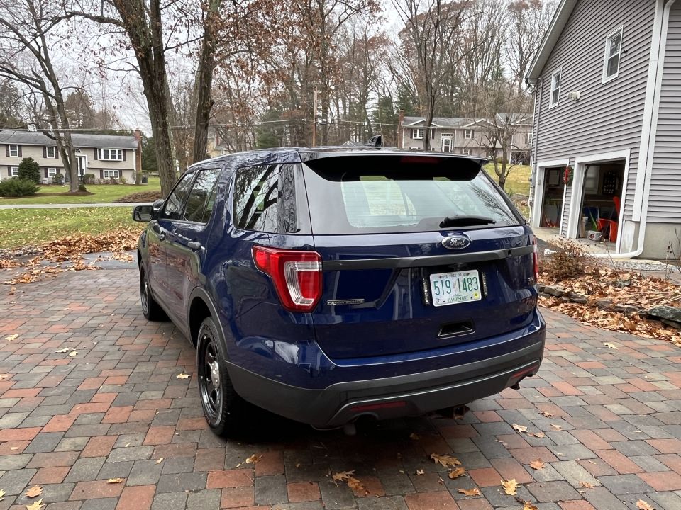 Rear three-quarter photo of a blue Ford Explorer SUV