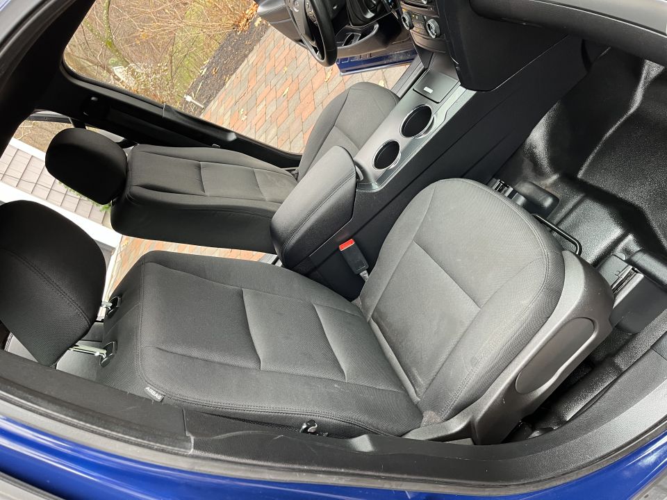 Front cloth seats and center console inside a blue Ford Explorer