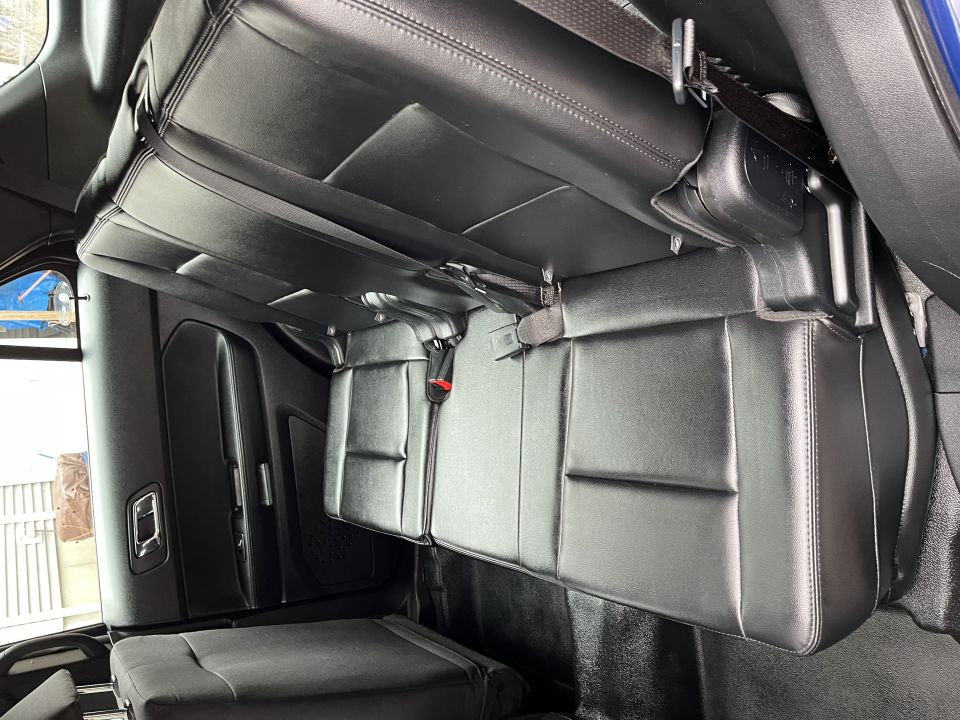 Rear leather bench seat inside a blue Ford Explorer