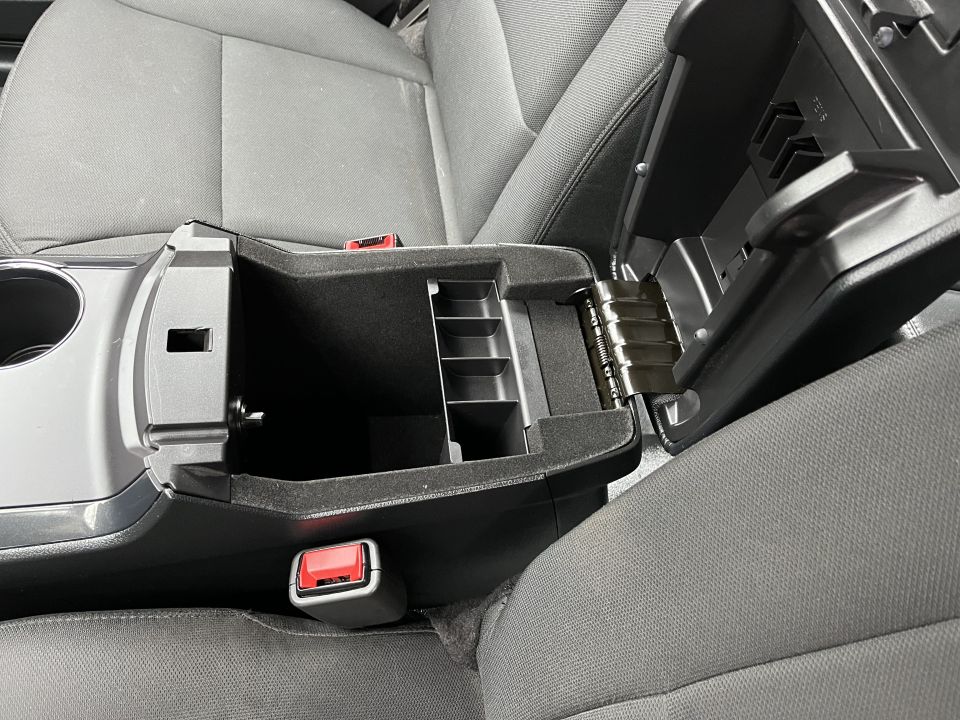 Open center console storage bin between two cloth front seats
