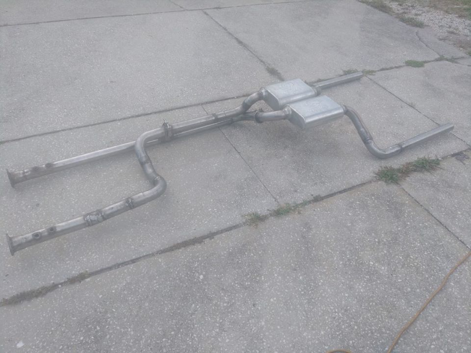 Dual exhaust system with two rectangular mufflers on concrete