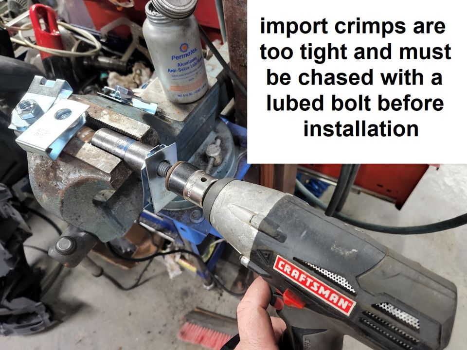 Aftermarket nuts included with bed bolts are crimped too much. If they're simply installed, they'll spin in their U-clips. To prevent that, chase each one with a lubricated bolt (anti-seize is what I use) before installation. Note that the vise is gripping the socket which holds the NUT - not the U-clip.
IF THE IMAGE IS TOO SMALL, click it.