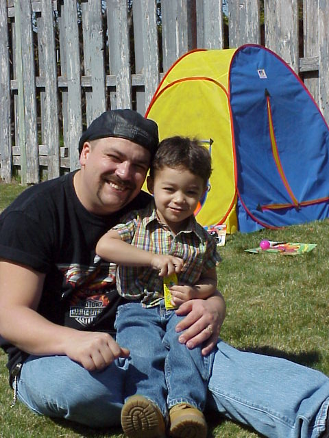 1989 Ford Bronco - A father and son enjoy a sunny day outdoors with a play tent in the background.