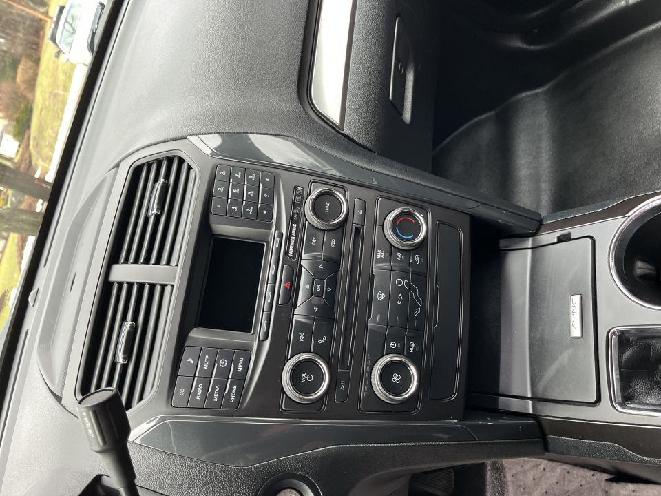 Center dashboard stack with radio, climate controls, and console