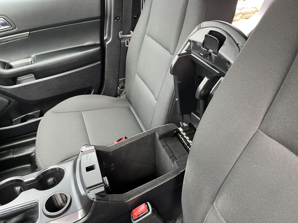 Open center console armrest storage bin between front seats