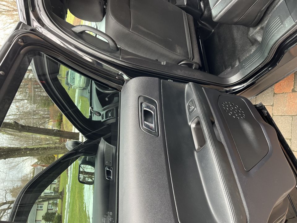Rear passenger door panel with window switch and armrest