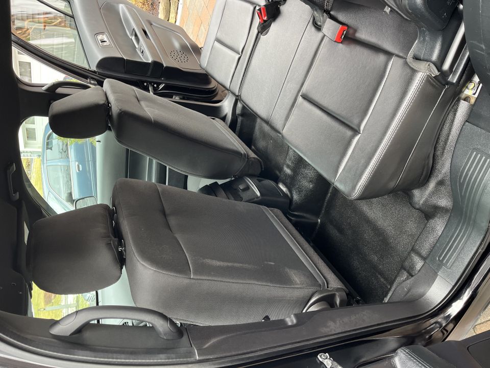 Folded and reclined rear seats viewed from open side door