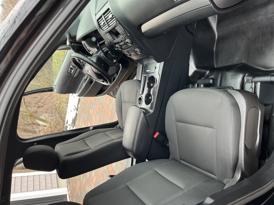 Front passenger seat and console viewed through open door